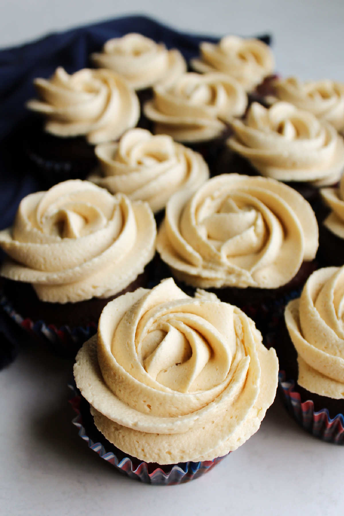 Chocolate cupcakes topped with brown sugar buttercream rosettes.