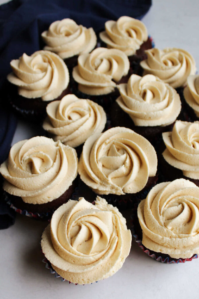 Looking down on cupcakes with brown sugar frosting piped on top.