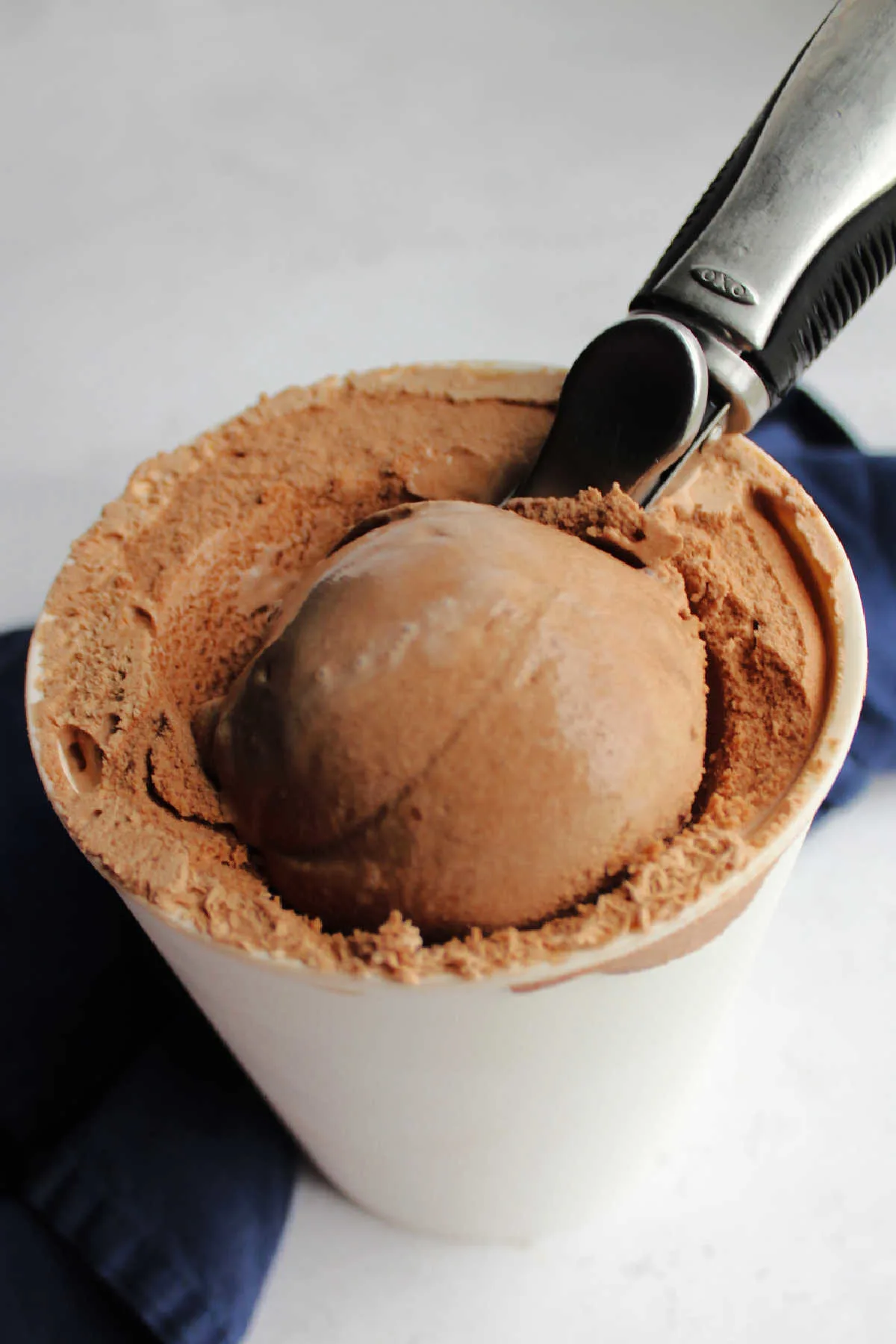 Using ice cream scoop to serve homemade chocolate ice cream.