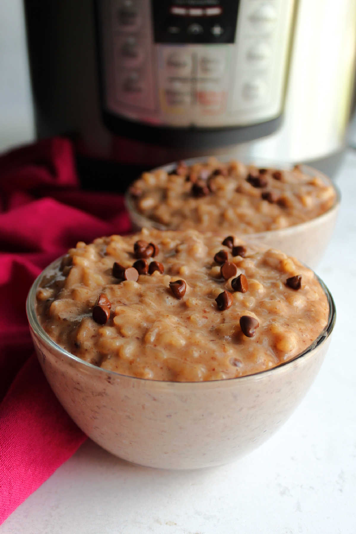 Bowls of chocolate rice pudding topped with mini chocolate chips.