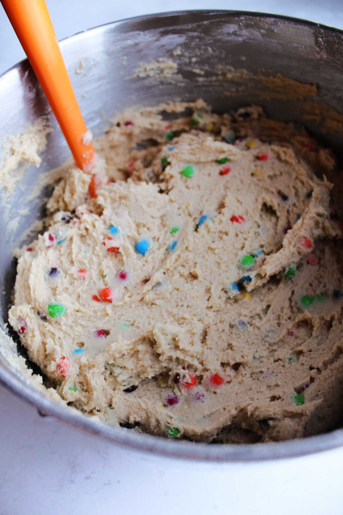 Mixing bowl filled with m&m cookie dough.