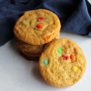 Chewy m&m cookies with golden cookies and colorful candy bits.
