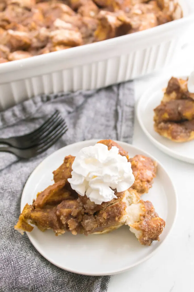Pumpkin french toast bake served with whipped cream.