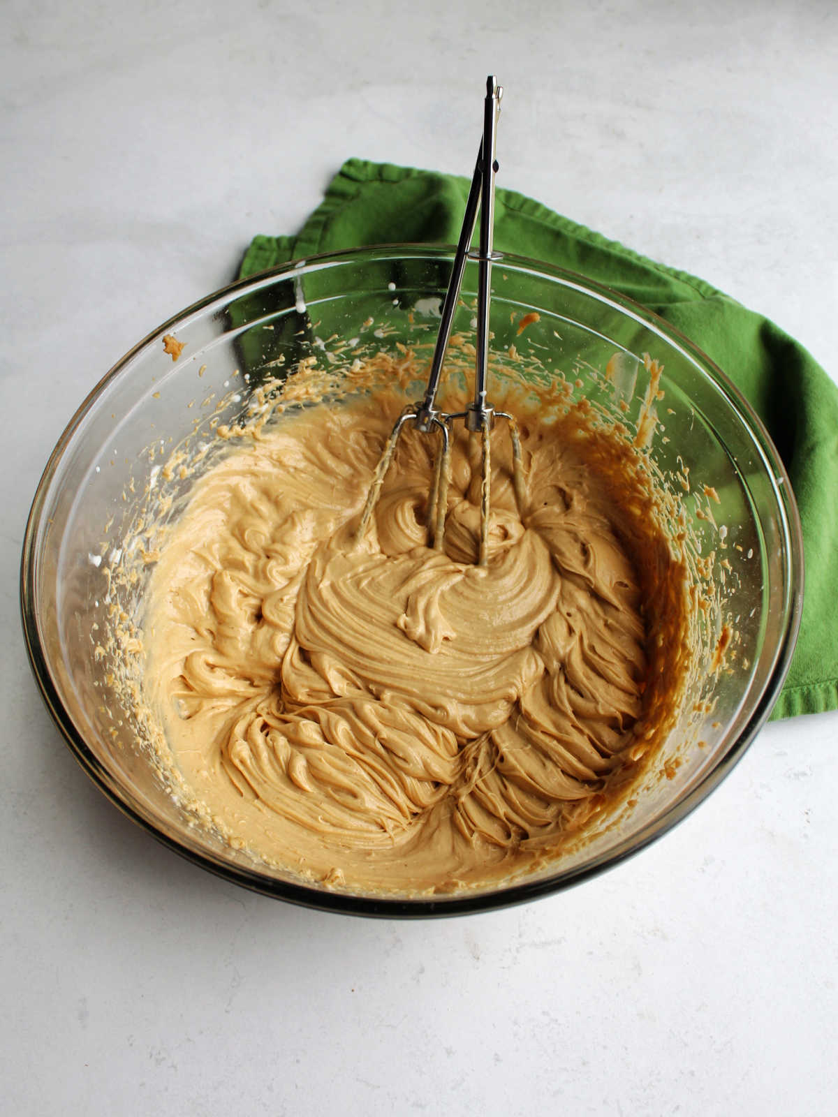 Creamy peanut butter filling in mixing bowl with beaters.