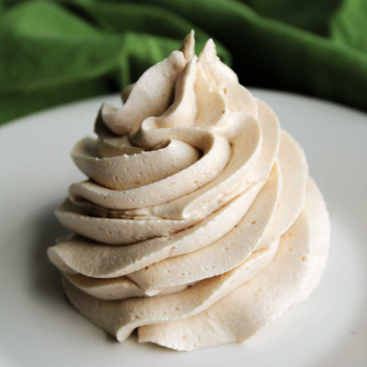 Large piped swirl of creamy apple butter buttercream frosting.