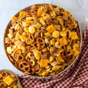 Bowl of chex mix with various kinds of crackers, cereals, pretzels and nuts ready to eat.
