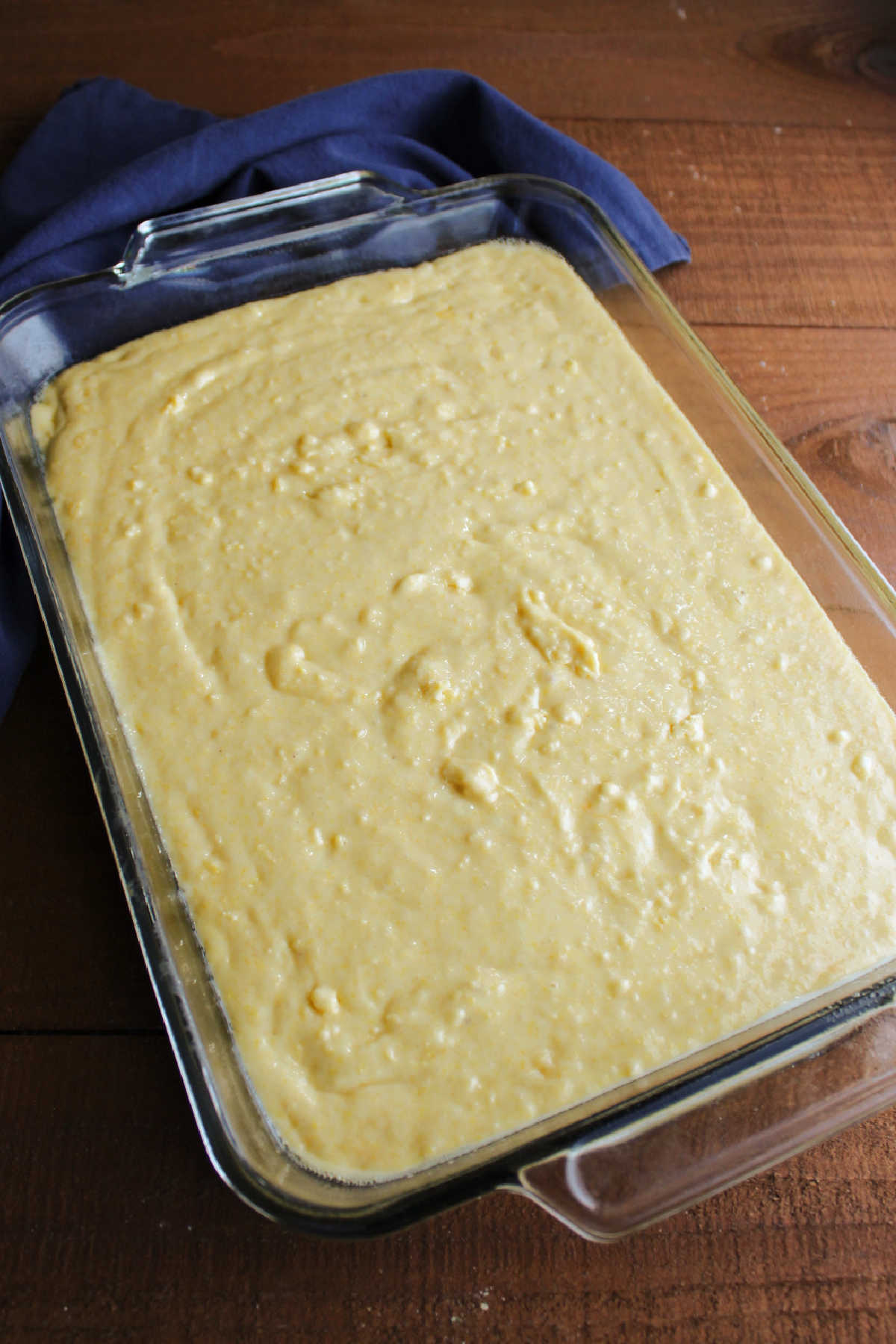 9x13-inch pan filled with cake mix cornbread batter, ready to bake.