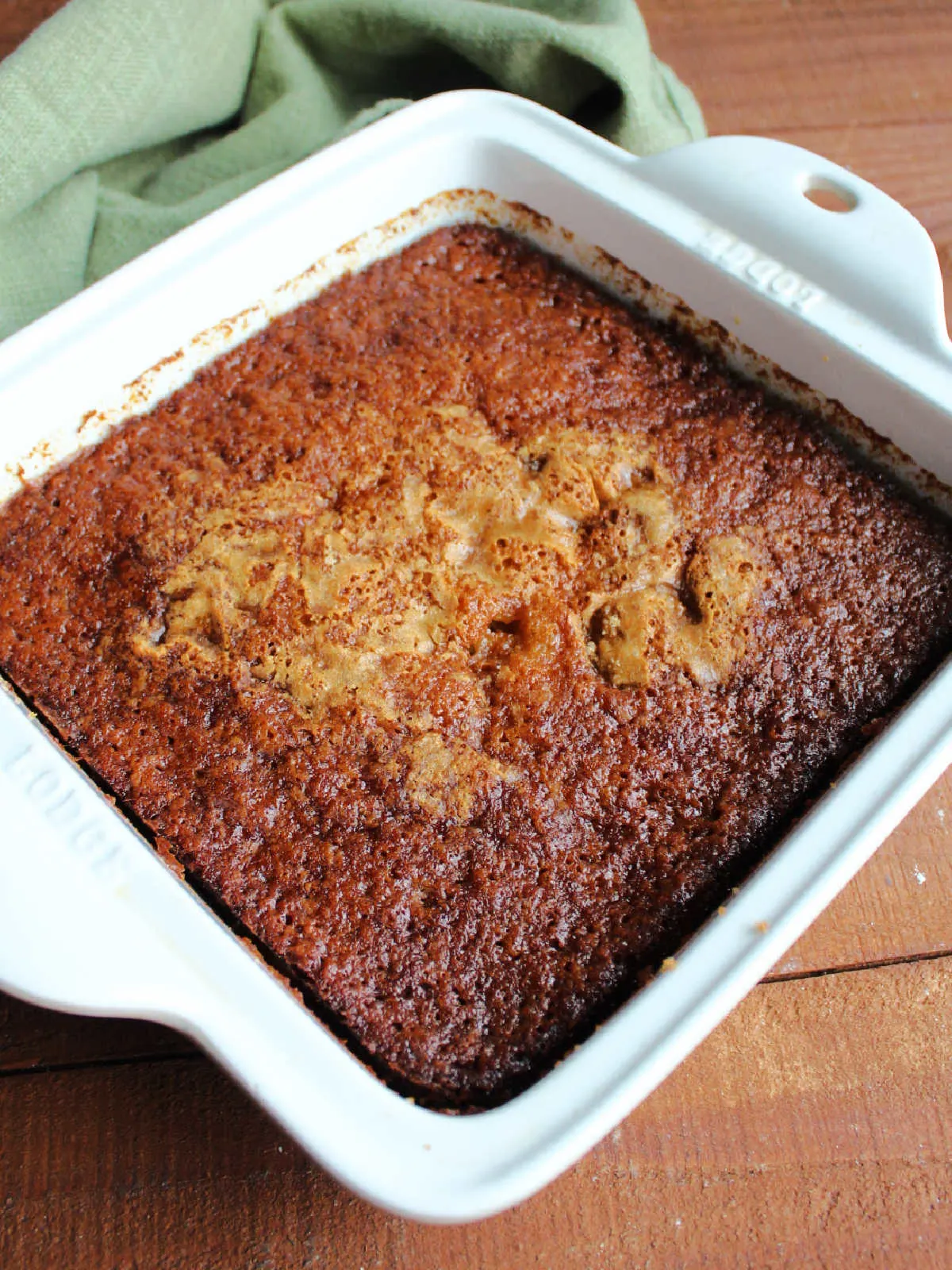 Freshly baked fruit cocktail cake with browned top, ready to serve.