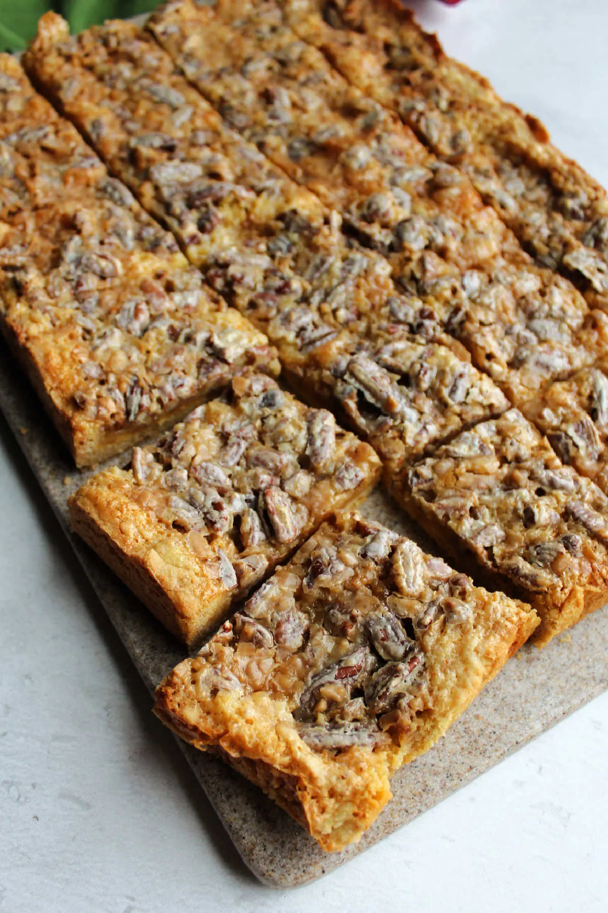 Pecan dream bars cut into squares and ready to serve.