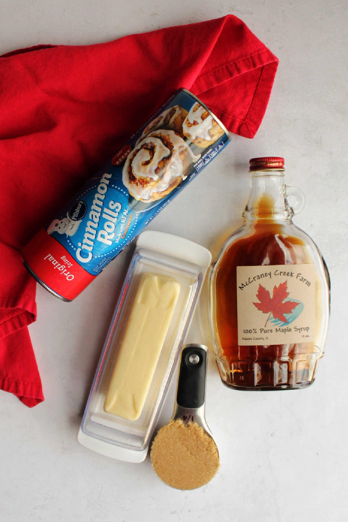 Ingredients: tube of cinnamon rolls, butter, brown sugar and pure maple syrup ready to be made into easy sticky buns.