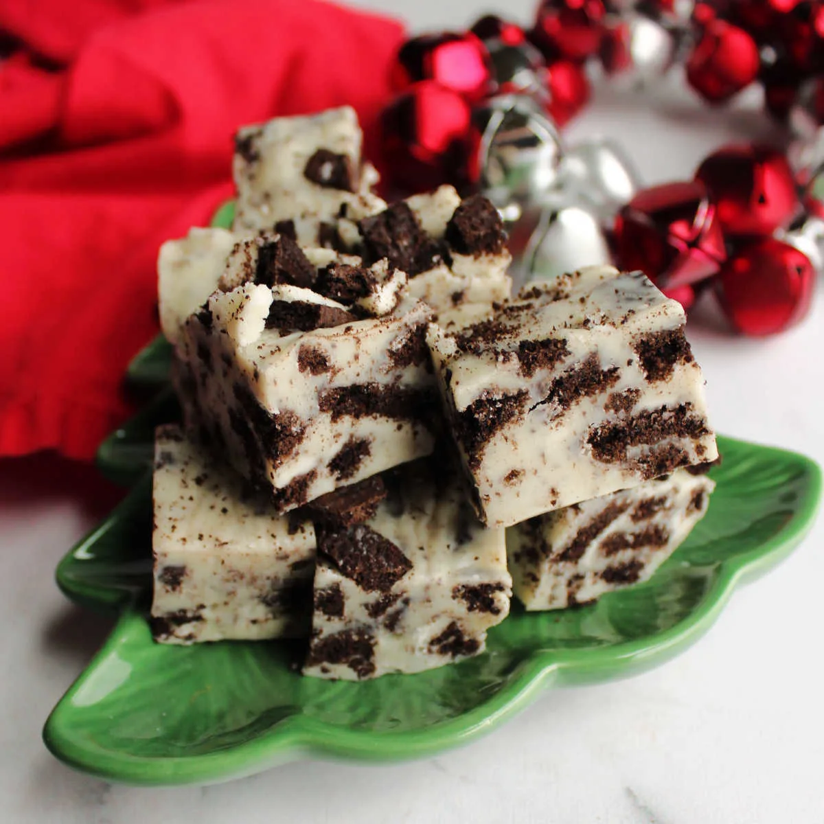 Plate of cookies and cream fudge with white fudge and bits of Oreo cookies.