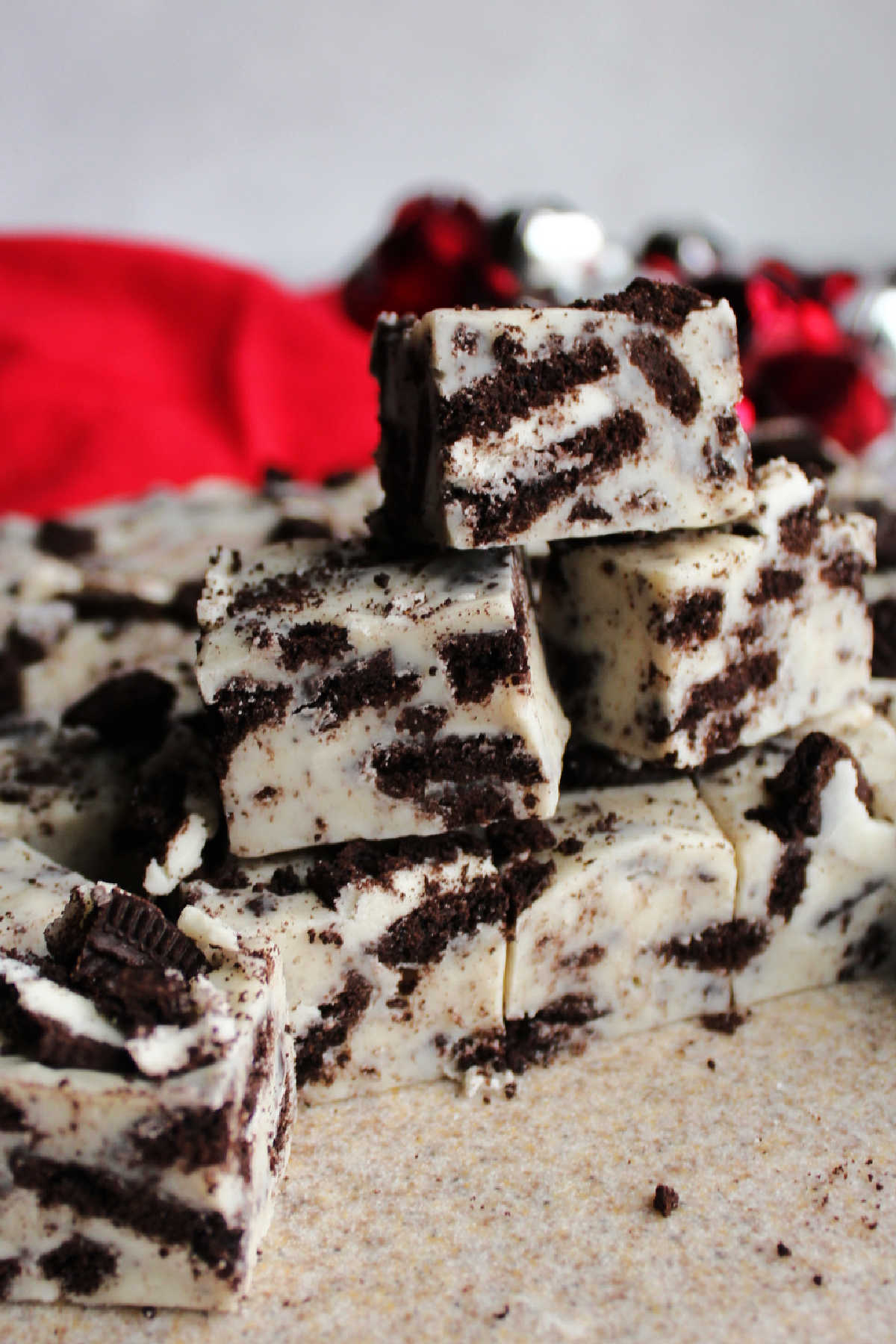 Stack of squares of cookies and cream fudge showing the Oreo cookies inside. 