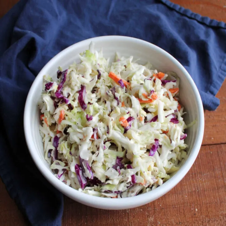 Bowl of creamy coleslaw with homemade condensed milk dressing.