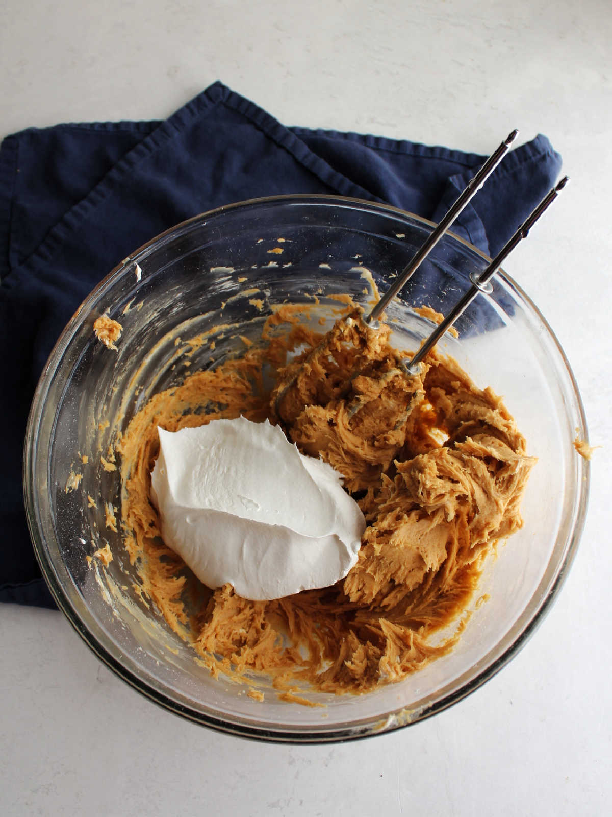 Adding cool whip to peanut butter and cream cheese mixture.