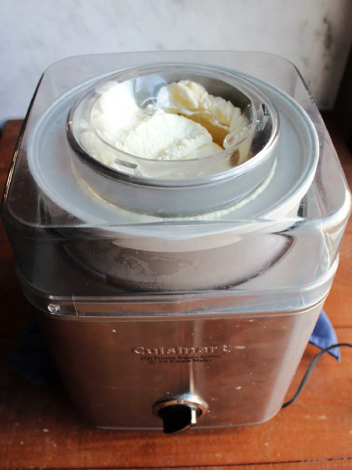 Freshly churned eggnog ice cream in ice cream maker.