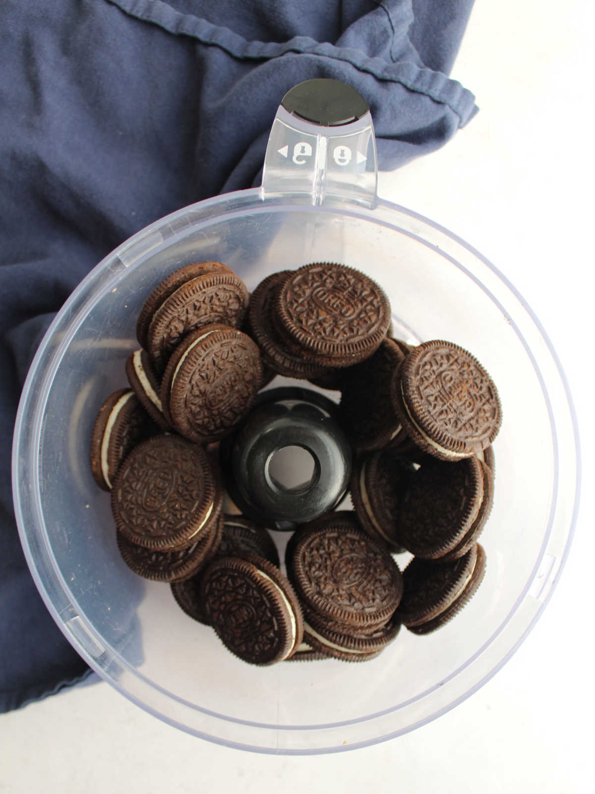 Whole Oreos in food processor, ready to be made into crumbs. 
