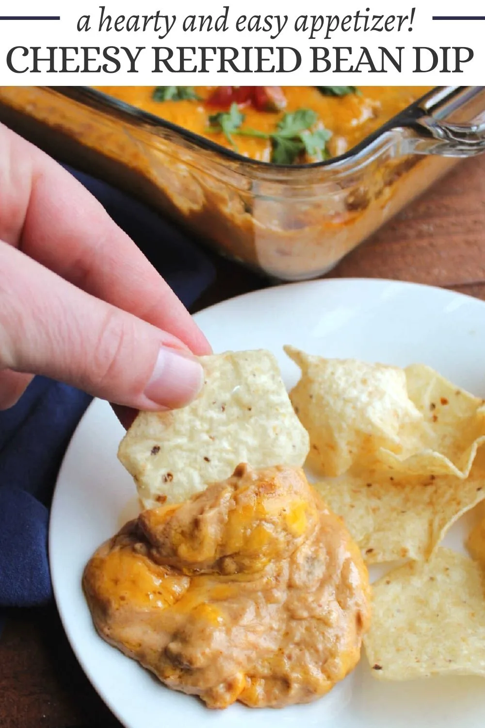 Cheesy refried bean dip is a creamy mixture of cheese, sour cream, beans and more. It is the perfect dip for tortilla chips and is great for game day or as an appetizer for a Tex-Mex feast.
