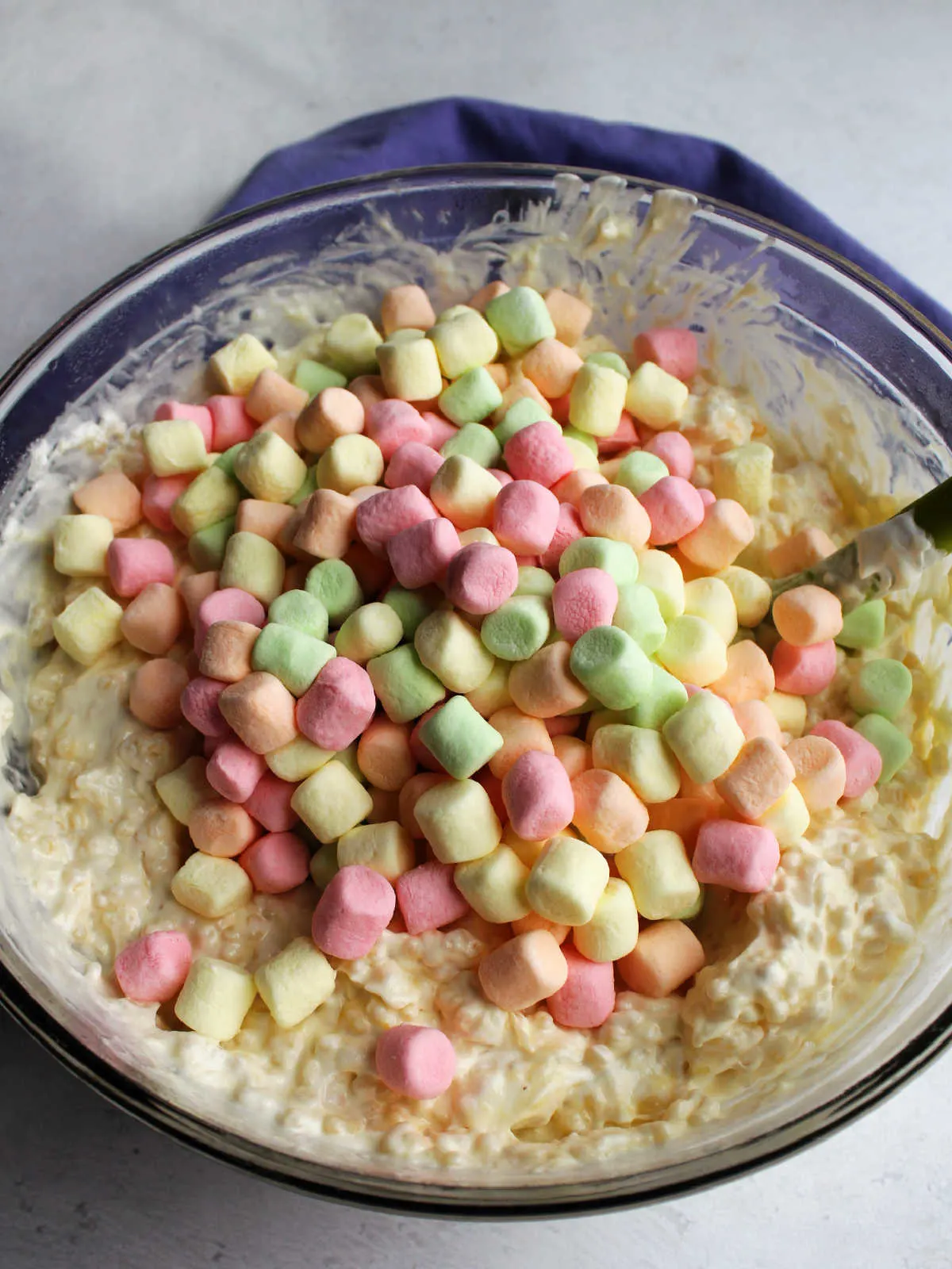Pastel colored fruity mini marshmallows ready to be stirred into pasta and custard mixture.