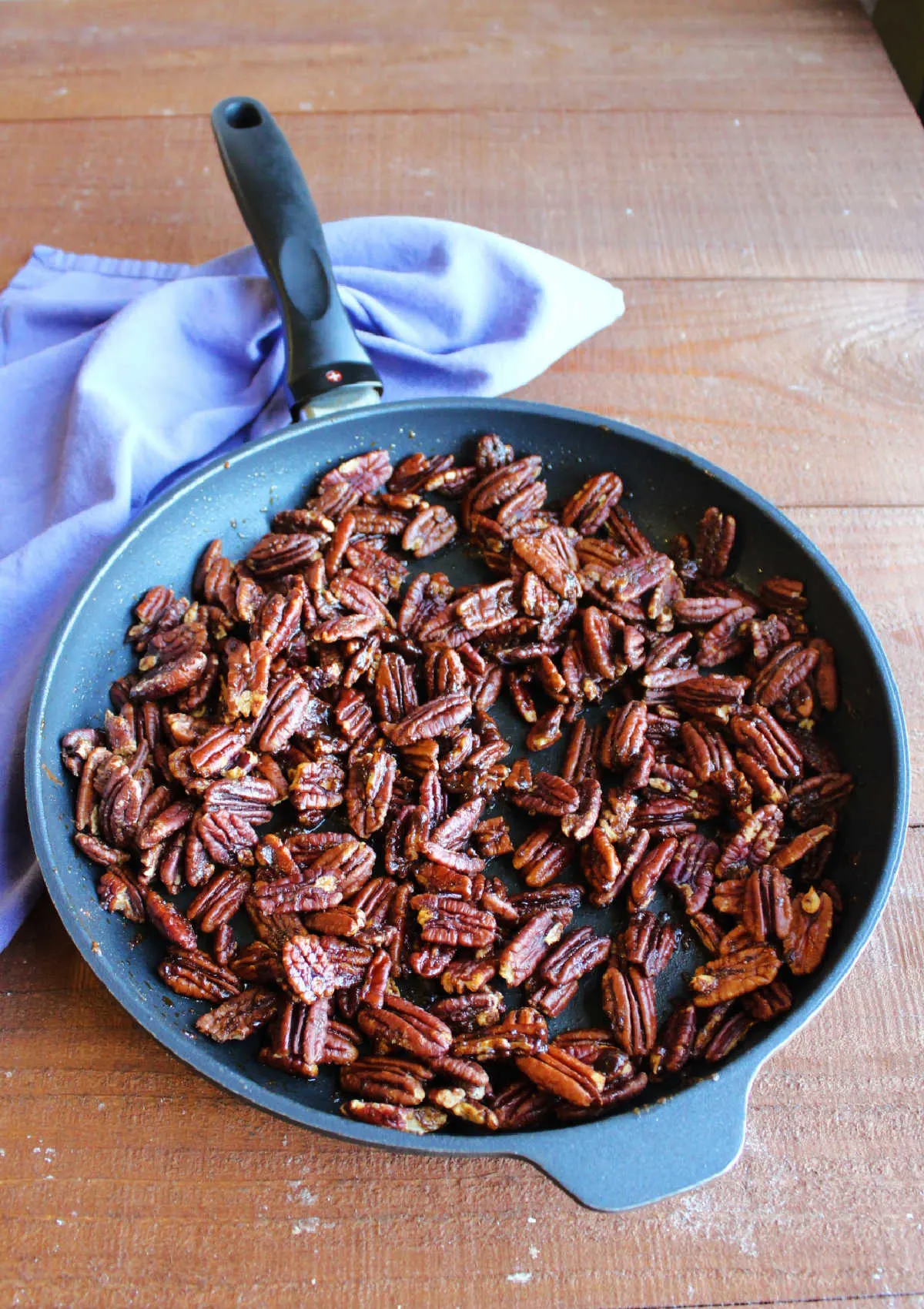 Large skillet filled with spiced pecans, fresh from the oven.