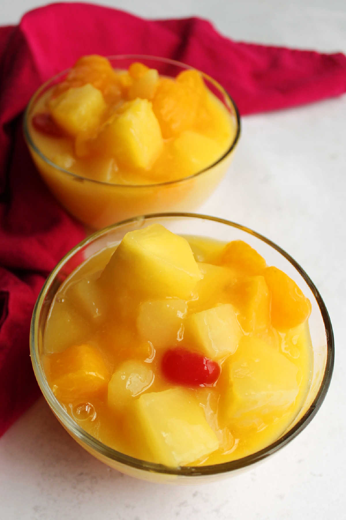 Close bowls of fruit salad in creamy pudding mixture.