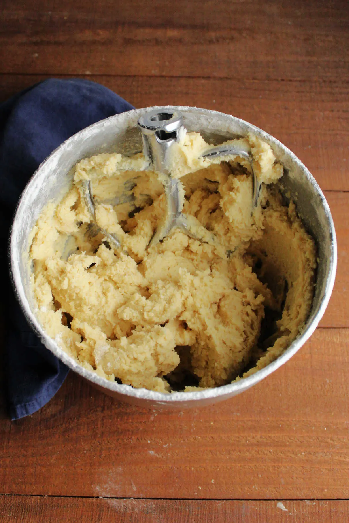 Mixer bowl filled with soft vanilla sugar cookie dough and mixer paddle, ready to chill.