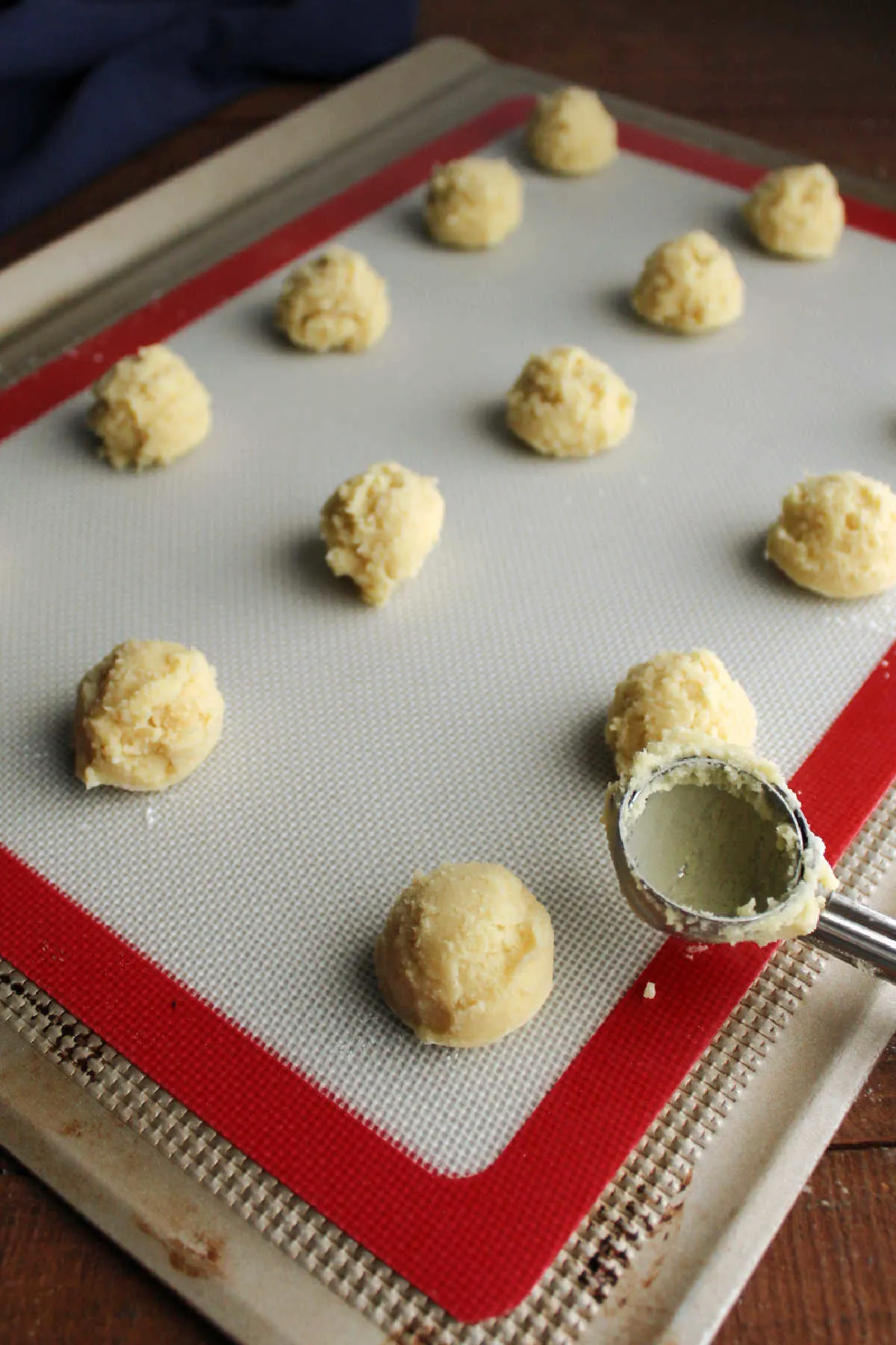 Small scoops of chilled cookie dough, ready to go in the oven.