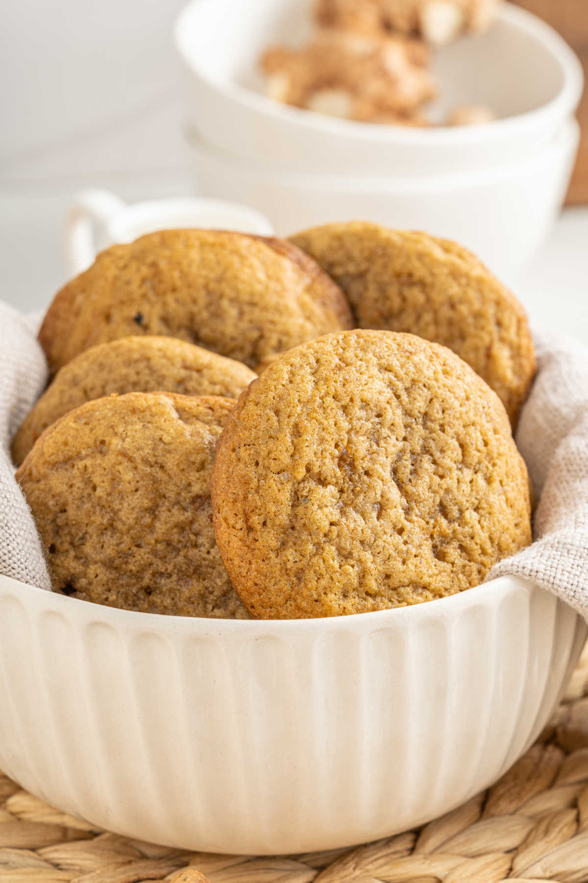 White bowl filled with large chai spiced cookies. 