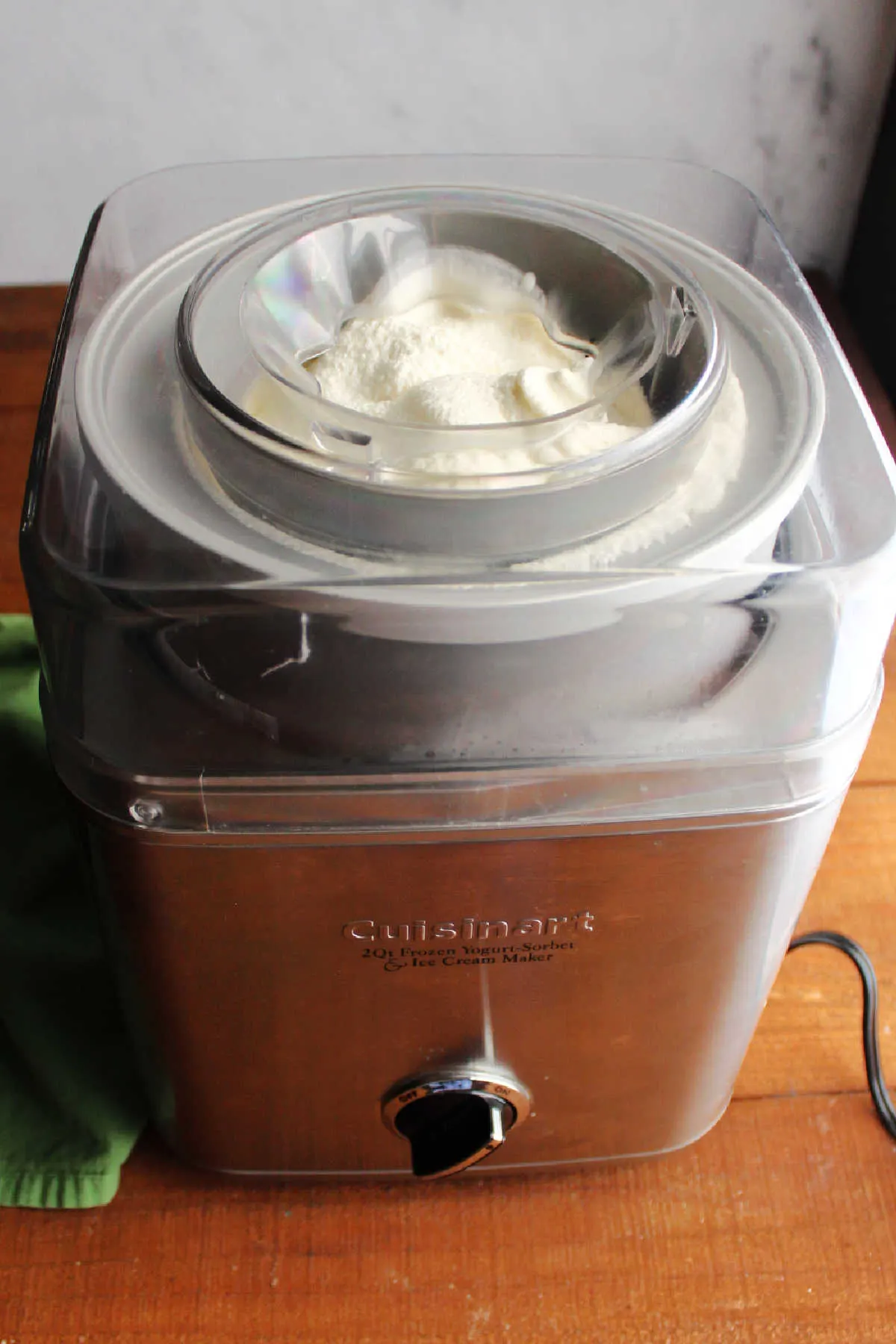 Churned key lime ice cream in ice cream maker, ready to be transferred to storage containers.