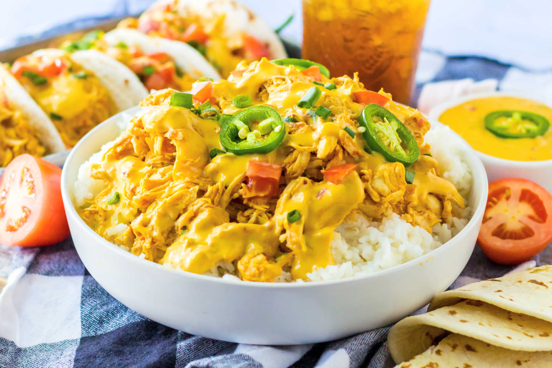 Rice bowl topped with shredded queso chicken, ready to eat. 