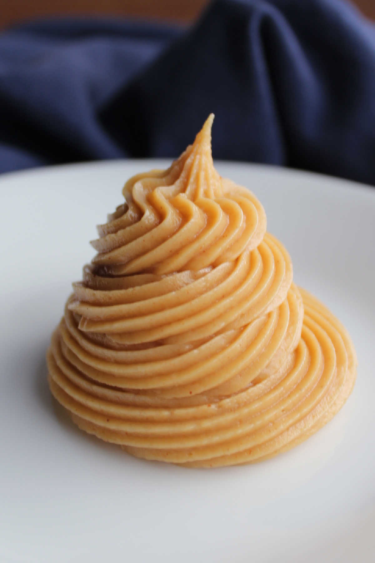 Piped swirl of peanut butter cream cheese frosting.