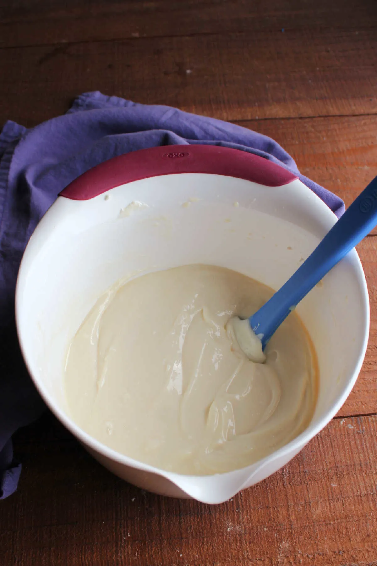 Mixing bowl of soft lemon cream cheese frosting ready to go into the refrigerator. 