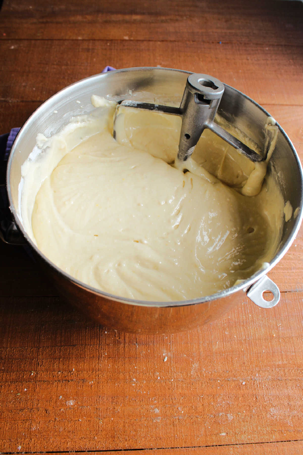 Mixer bowl of completed vanilla cake batter showing thick texture.