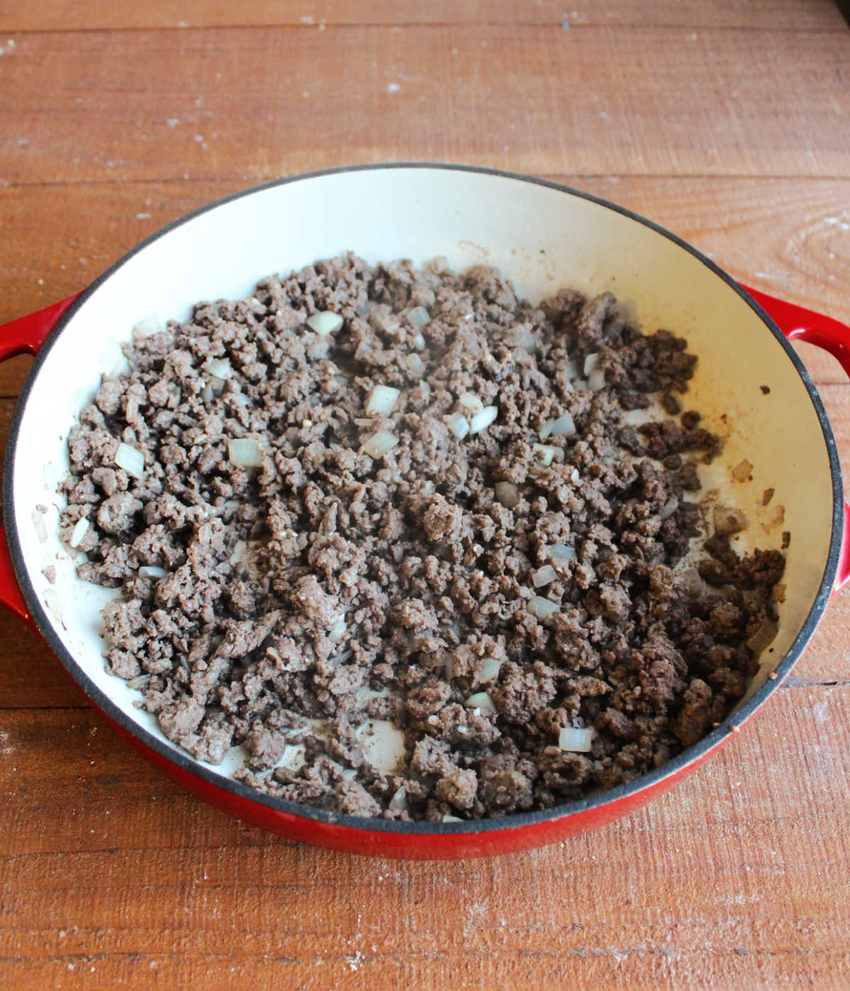 Pan of browned ground venison with diced onions.