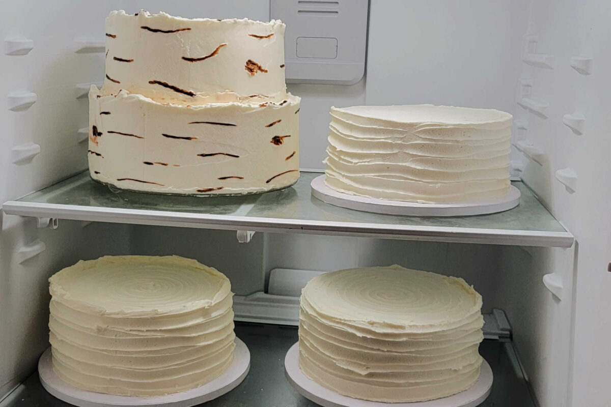 Chilling bottom cake layers of vanilla wedding cake along with extra vanilla cakes for cutting.