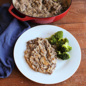 Dinner plate with creamy rice with venison and mushrooms served with steamed broccoli.