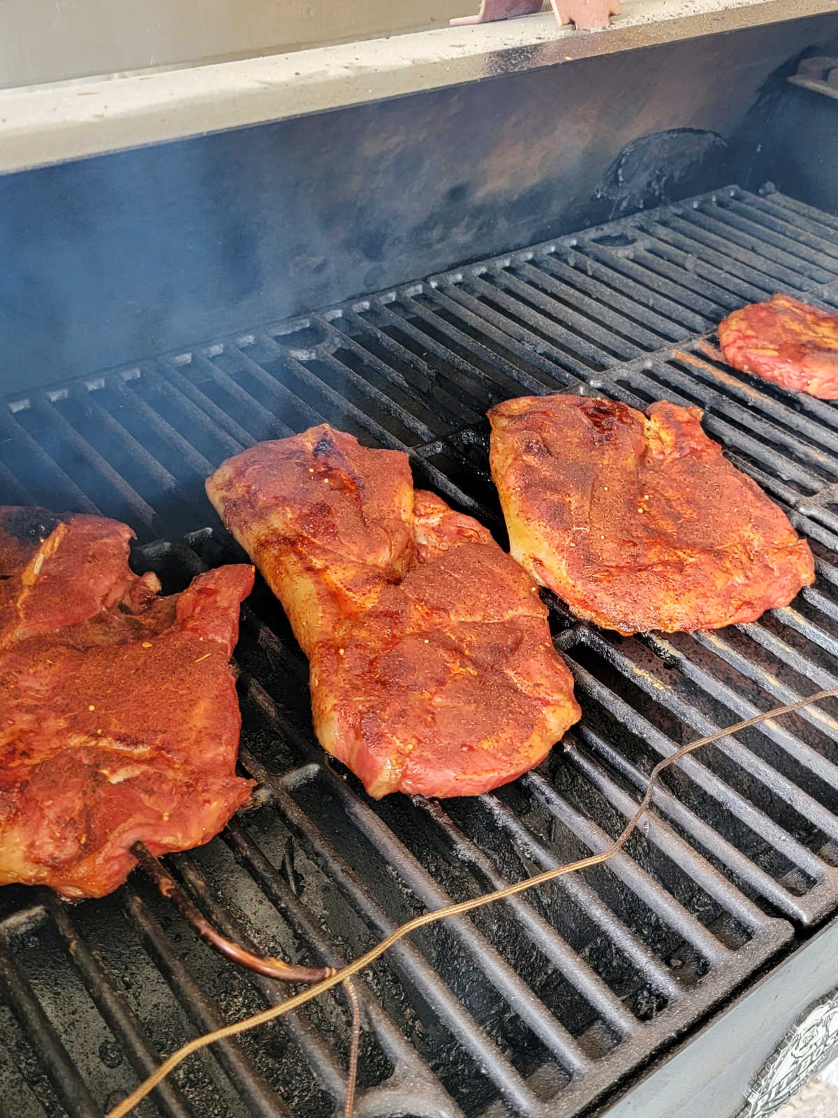 Smoked pork steaks with dry rub, they are partially cooked and ready for the sauce.