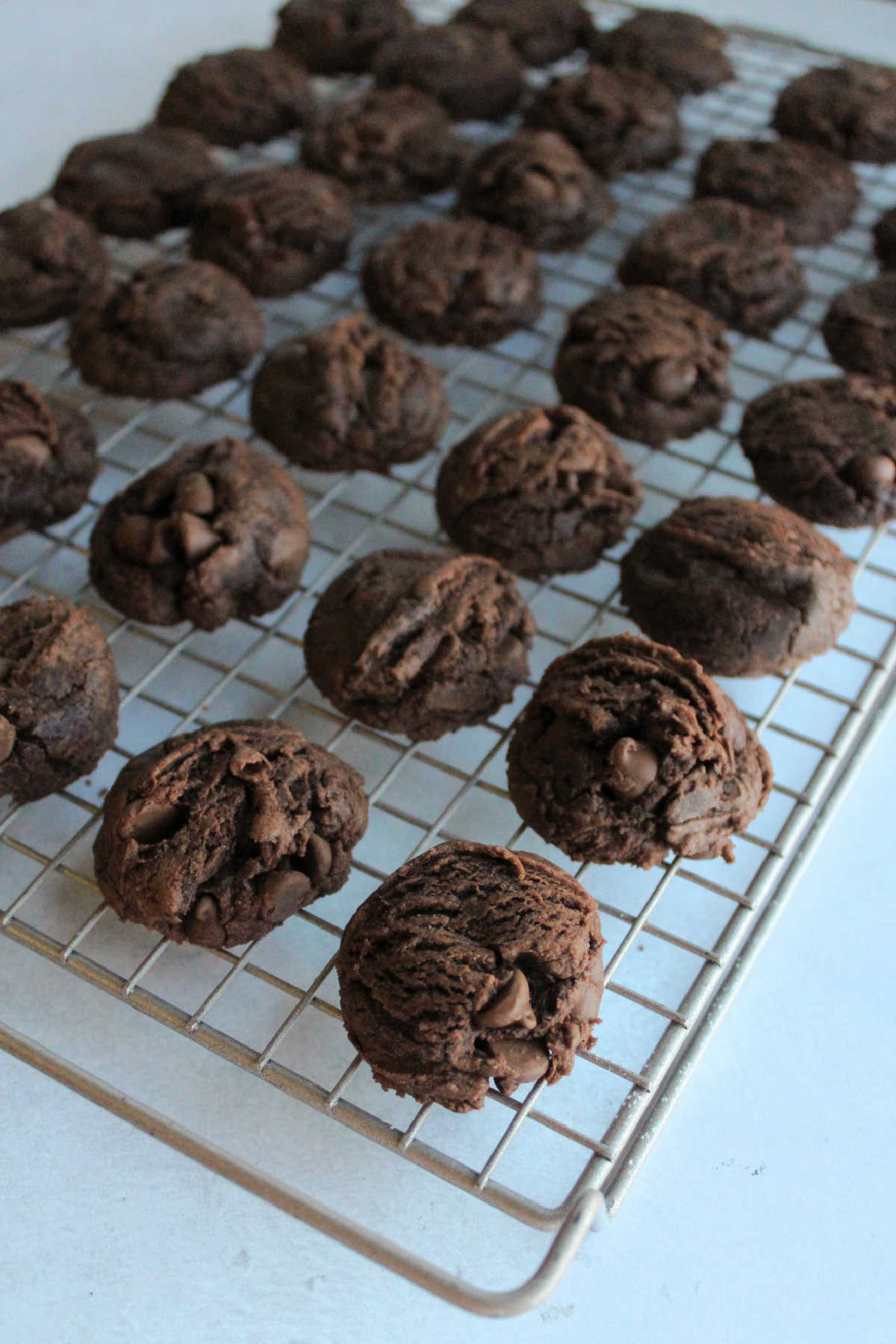 Baked brownie mix cookies on wire cooling rack.