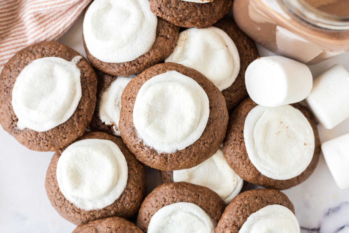 Pile of hot chocolate cookies with melted marshmallows baked on top.
