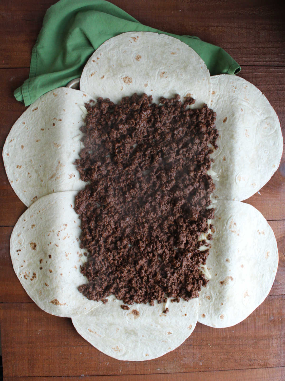 Taco seasoned ground venison spread out over the cheese layer.