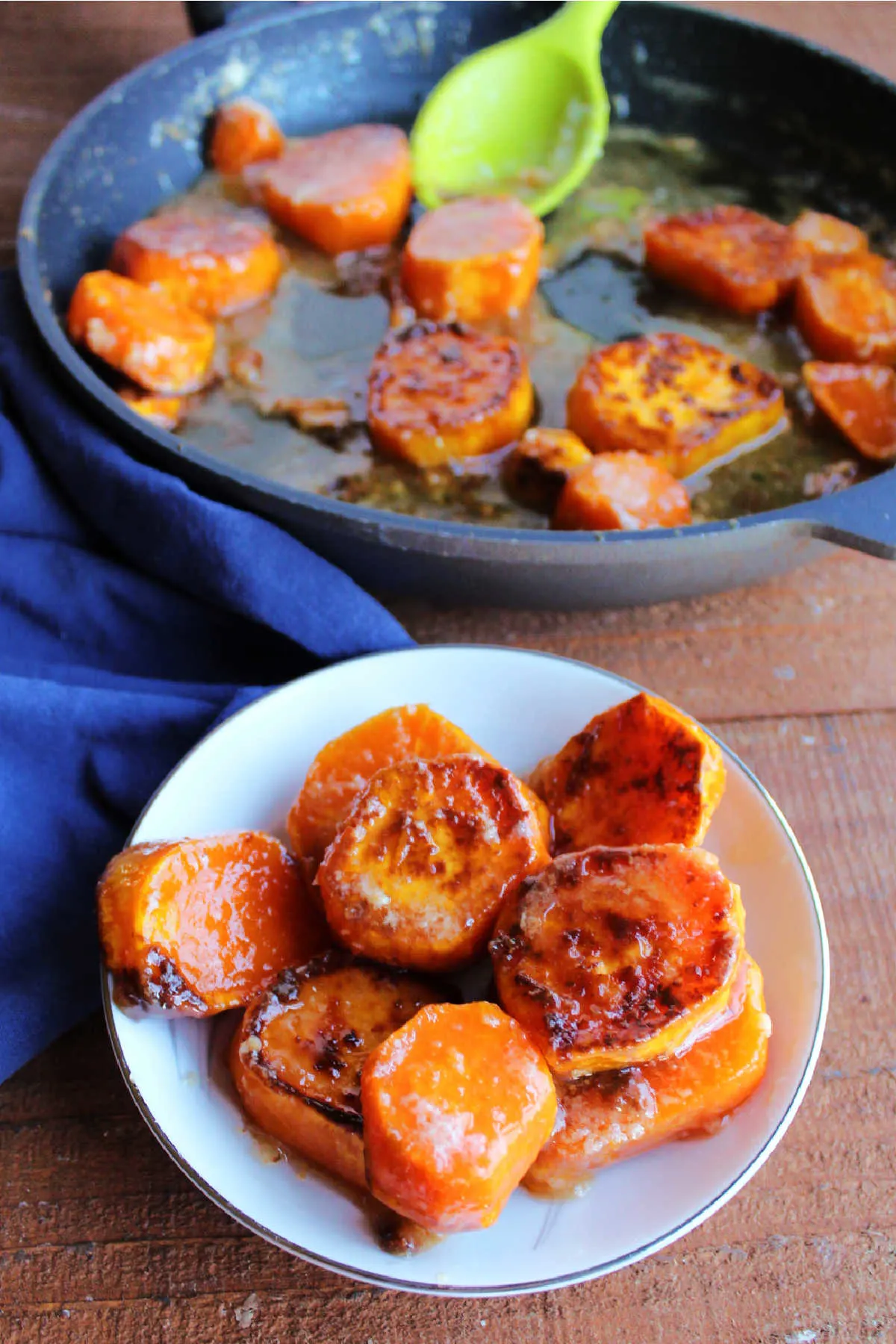 Small bowl of skillet sweet potatoes with skillet in the background.