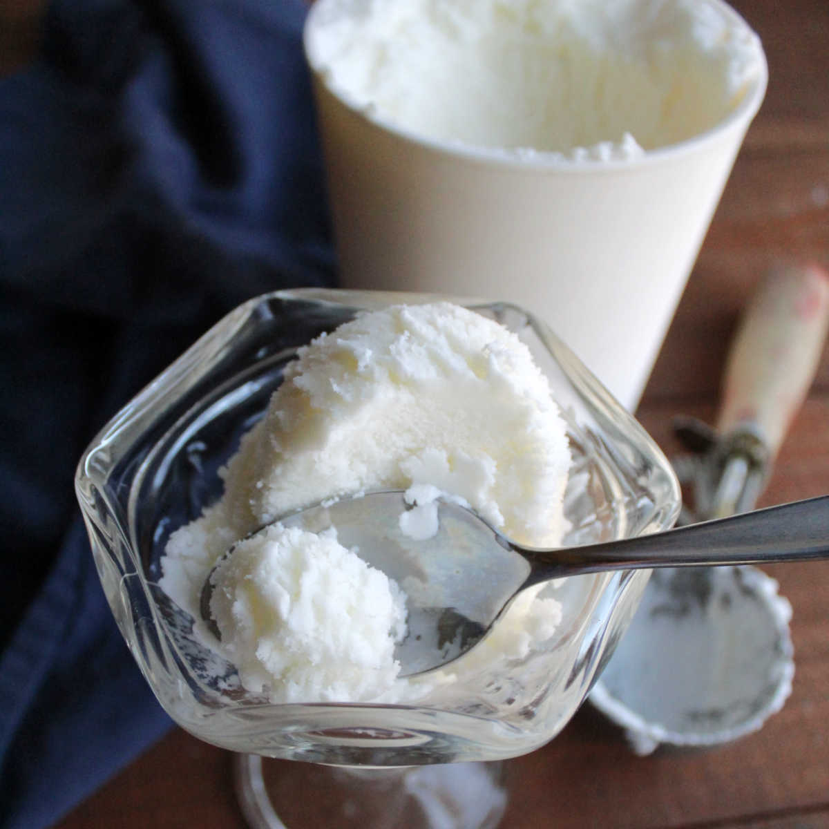 Spoon getting a bite of smooth vanilla half and half ice cream.