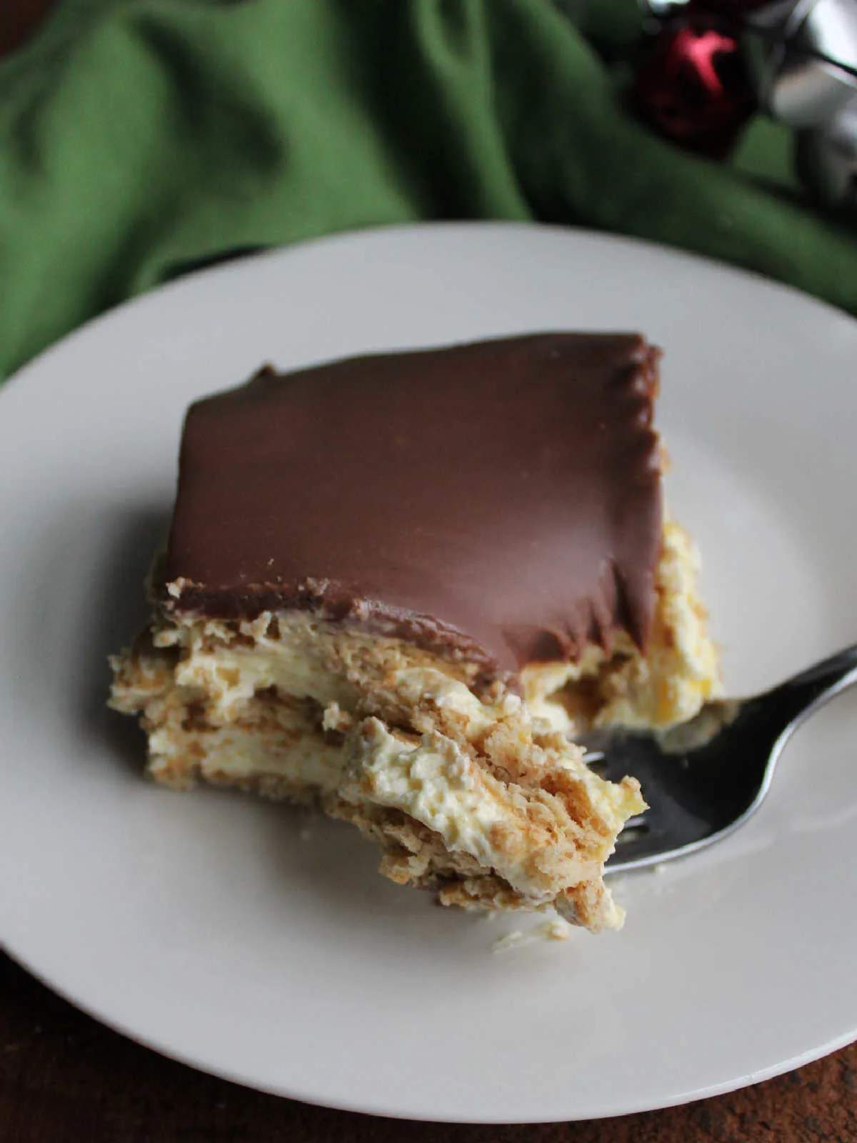 Bite of no bake eclair cake on fork, ready to eat. 