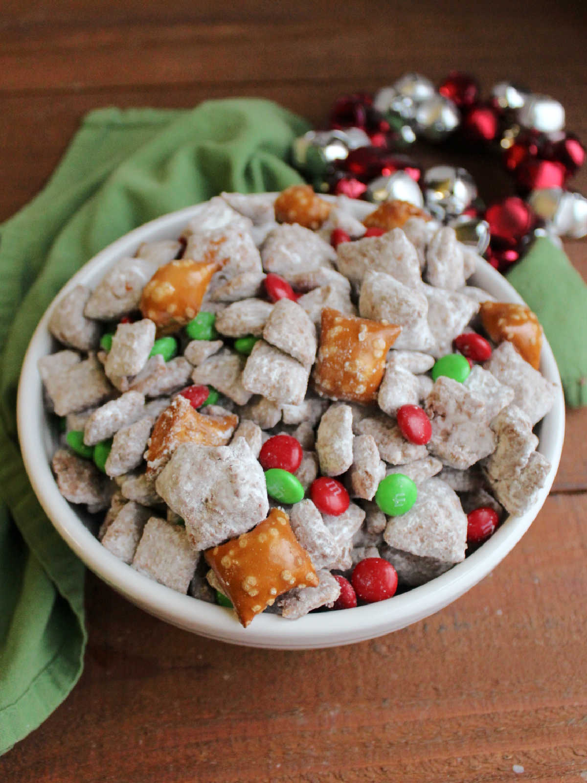Loaded puppy chow with peanut butter filled pretzels and holiday M&Ms inside, ready to eat. 