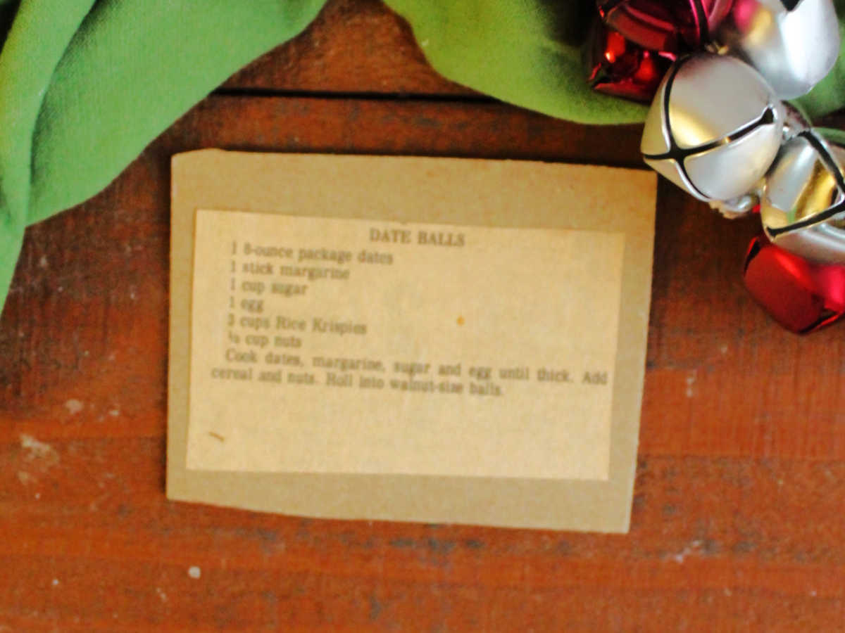 Yellowed newspaper clipping with vintage date ball recipe glued to piece of cardboard.