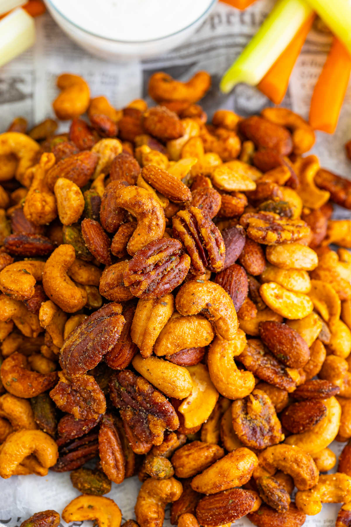 Close up of finished buffalo ranch spiced nuts showing the coating of seasonings distributed over all of the different kinds of nuts. 