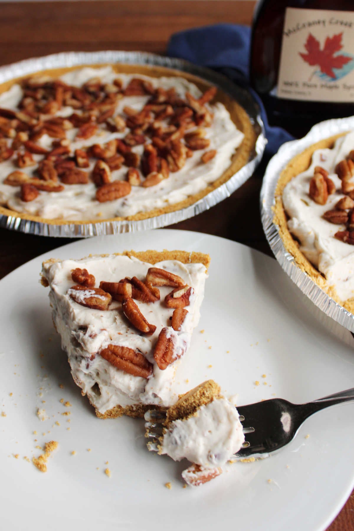 No Bake Pecan Cream Pie 11 Bite of pecan cream pie with graham cracker crust on fork, ready to eat.