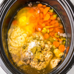Crockpot Chicken and Dumplings 12 Crockpot filled with chicken, broth, veggies, and soups, ready to cook.