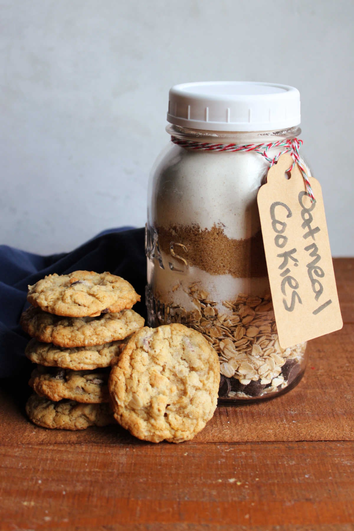 Freshly baked oatmeal chocolate chip cookies next to a quart jar of homemade oatmeal chocolate chip cookie mix. 