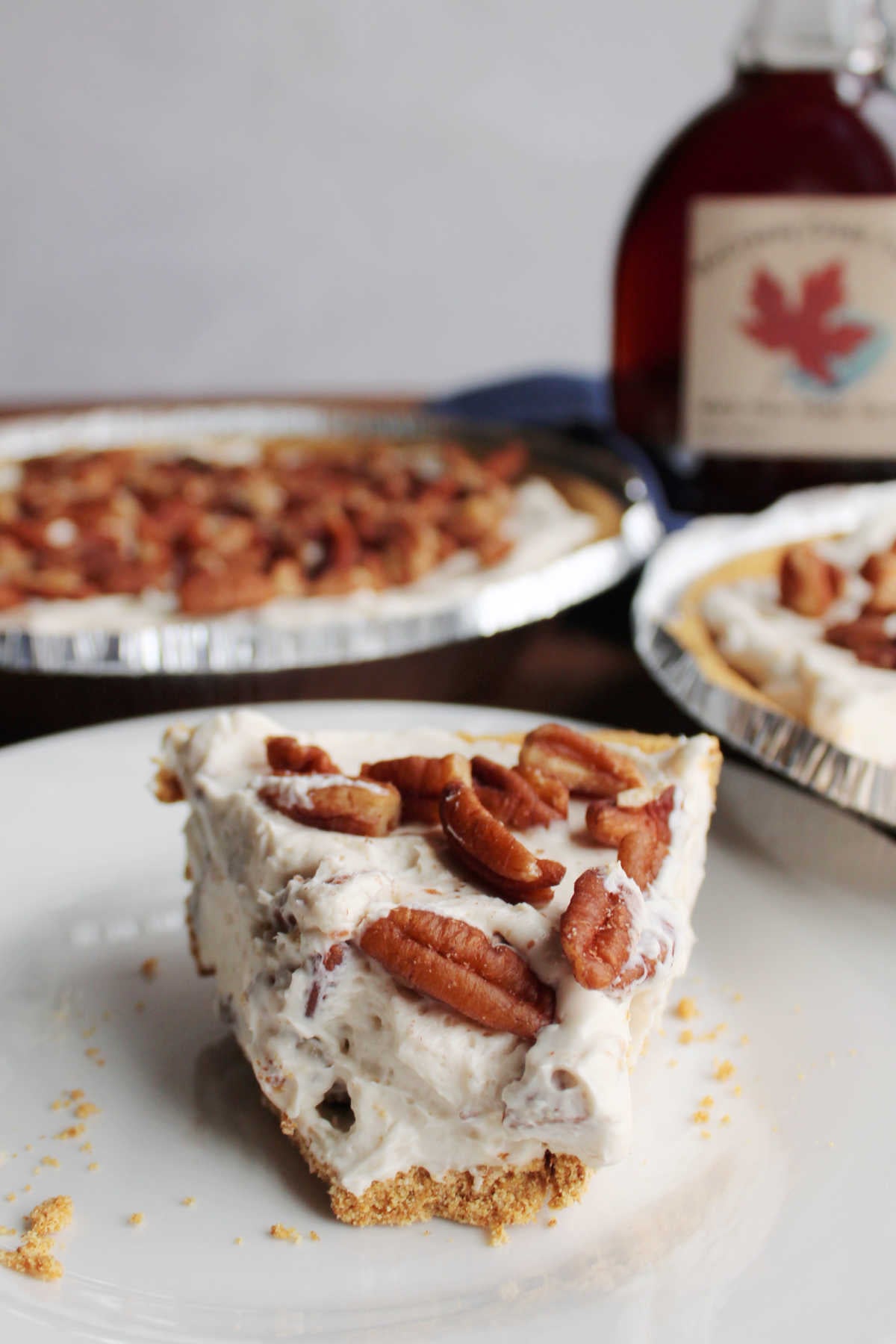 No Bake Pecan Cream Pie 12 Slice of no bake pecan pie with tip missing showing creamy texture with bits of pecans throughout and toasted pecans on top.