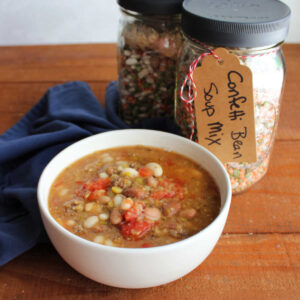 Confetti Bean Soup Mix In A Jar 11 Bowl of confetti bean soup next to a couple of jars of homemade bean soup mix.